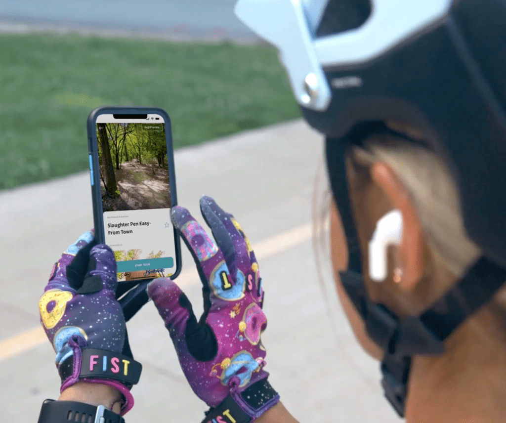 Mountain biker using TrailPilot on her phone.